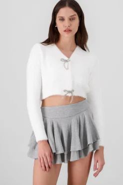 Cardigan botones moños brillos