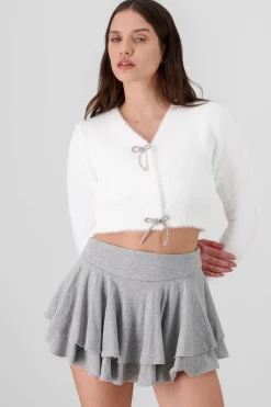 Cardigan botones moños brillos