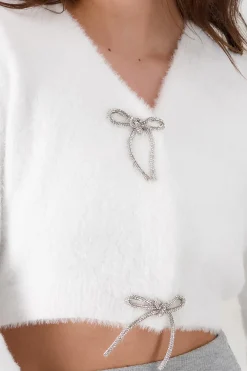 Cardigan botones moños brillos