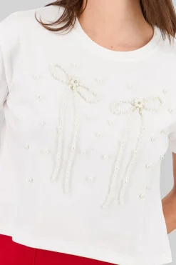 Playera manga corta detalle moños perlas