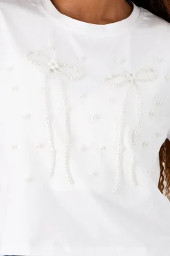 Playera manga corta detalle moños perlas